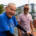 elderly man and younger man smiling on a dock in a marina
