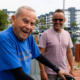 elderly man and younger man smiling on a dock in a marina